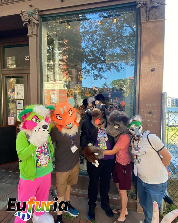 Group of fursuiters posing in front of the venue